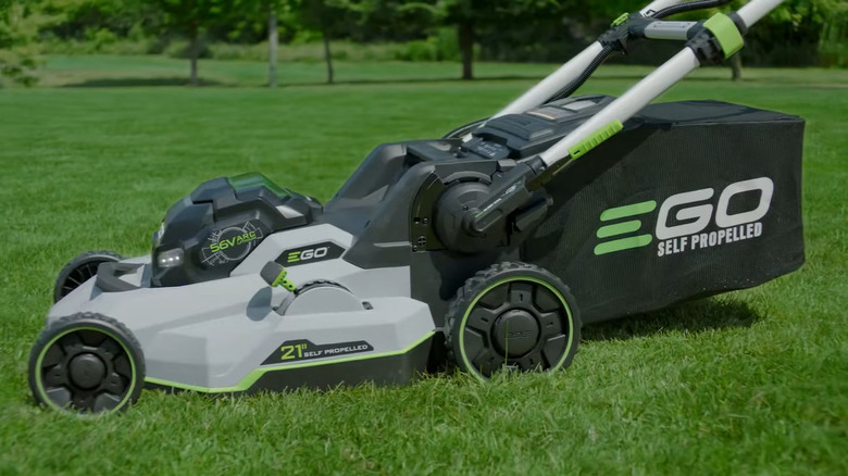 A self-propelled EGO Power+ lawn mower sitting in a field
