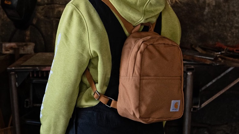 person wearing Carhartt mini backpack