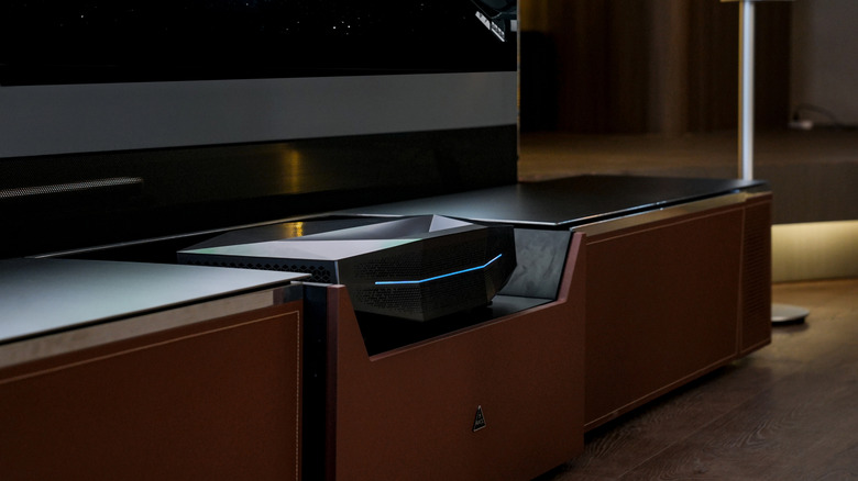 The Awol Vision Aetherion Max projector placed in a TV unit