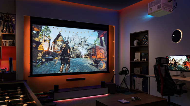 The BenQ X3100i projector mounted on the ceiling of a gaming room, projecting a game on a screen