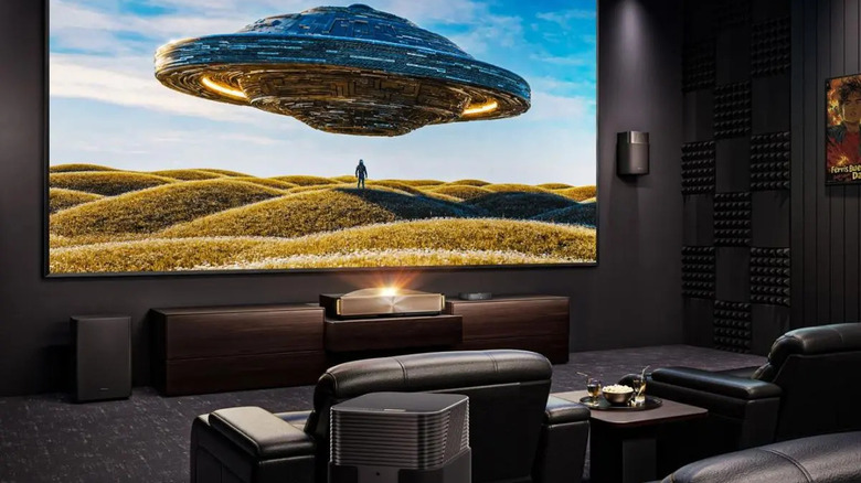 The Hisense L9Q projecting onto a screen in a home theater room