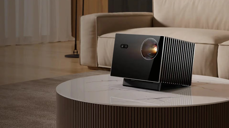 The Valerion VisionMaster Max projector placed on a round marble table