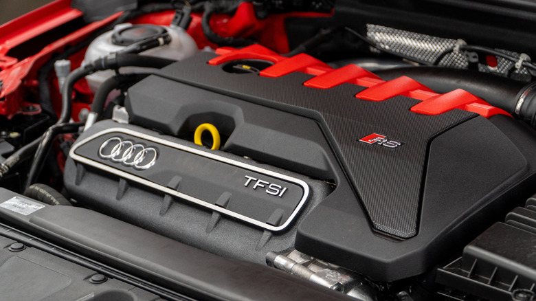 The engine bay of a red 2025 Audi RS3.