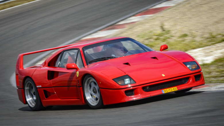 Front 3/4 shot of a red Ferrari F40 driving around the Zandvoort race track.