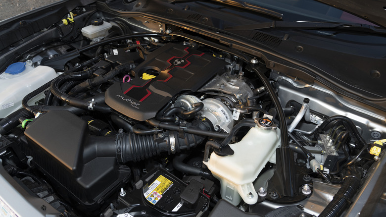 The engine bay of a silver 2018 Abarth 124 Spider.