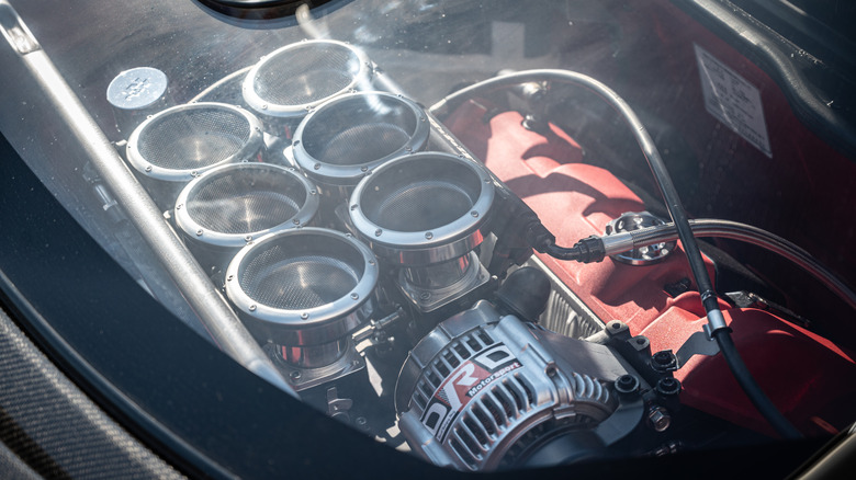 Shot of the engine of a red 2022 Acura NSX through its rear window.