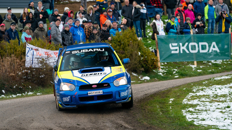 Head-on action shot of a 2003 Subaru Impreza WRX STI taking a corner at the Lavanttal Rallye.