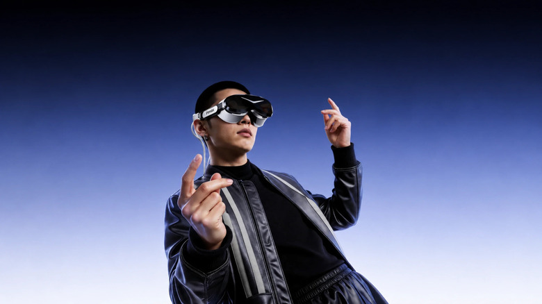 A person wearing a Pimax Dream Air VR headset against a blue-white background
