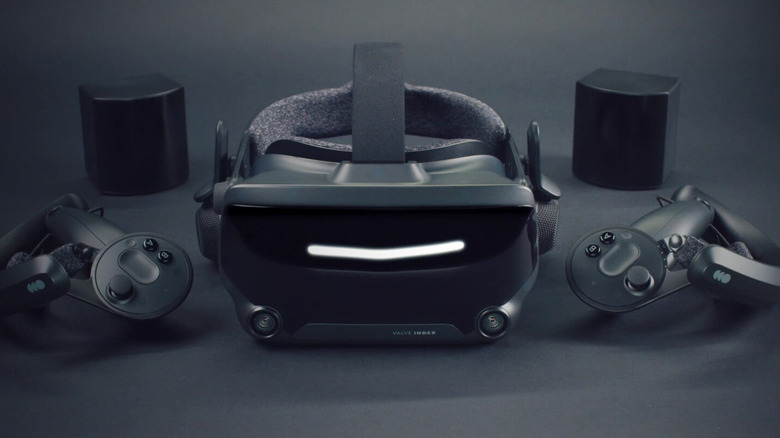 The Valve Index headset, controllers, and base units on a grayish-black surface