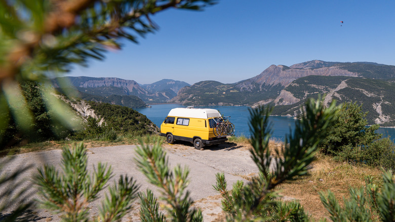 A can parked near a scenic body of water.