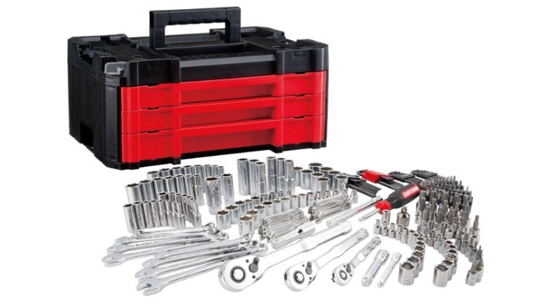 Black tool case with red drawers and many pieces of tools