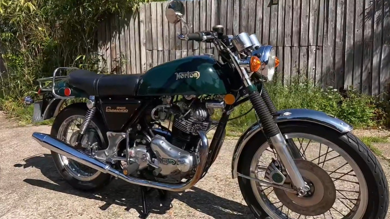 A classic 1975 Norton Commando 850 motorcycle in pristine condition, parked outdoors.