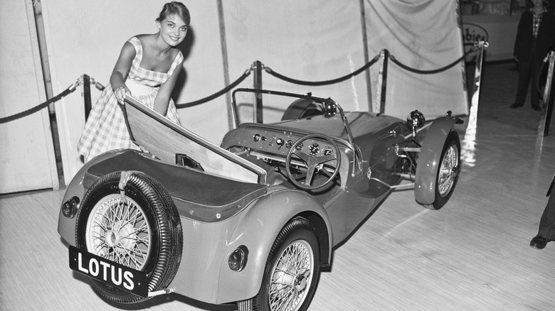 Woman posing with original Lotus Seven