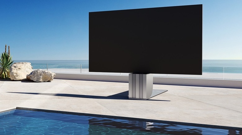 C Seed N1 TV in front of a luxurious swimming pool