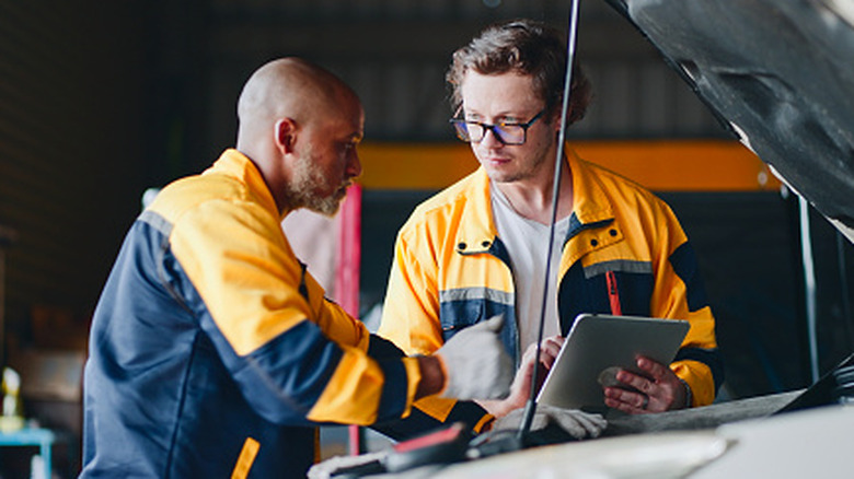 technicians review engine data