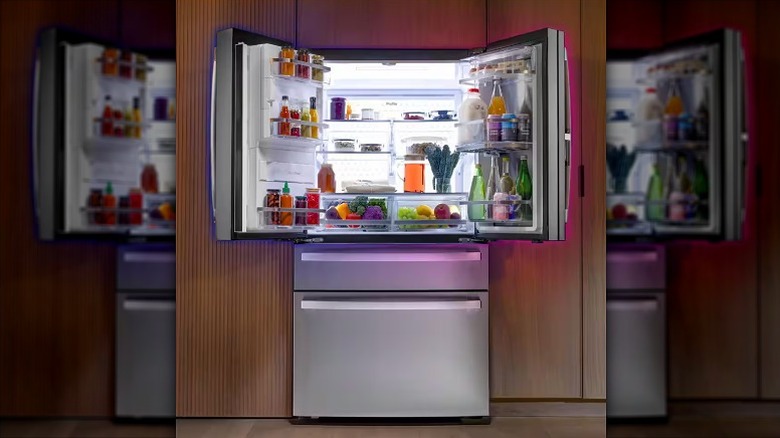 Refrigerator with top freezer door open.