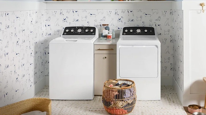 Two load washers placed in a laundary room.
