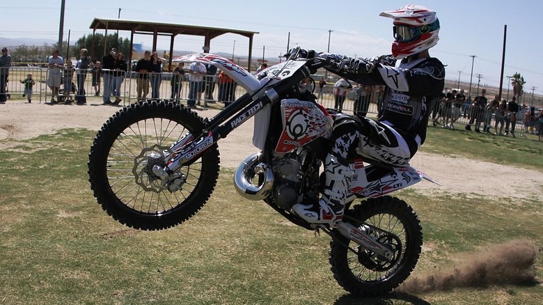 Motocross rider popping a wheelie