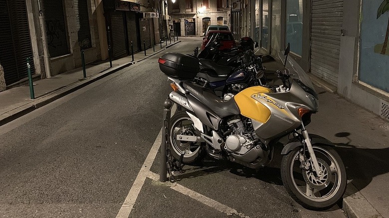 Motorcycles parked on a street at night