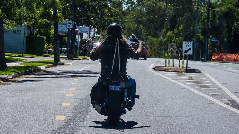 Person riding a Harley Davidson with high handlebars