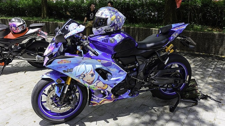 Sport bike with a helmet sitting on the gas tank