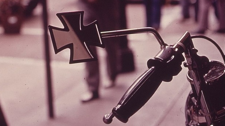 Motorcycle handlebar and mirror with street in background