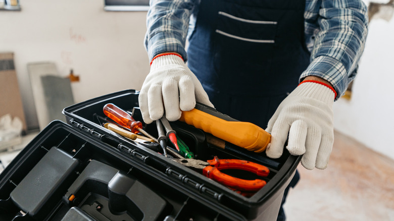 tool user looking for something in a tool box