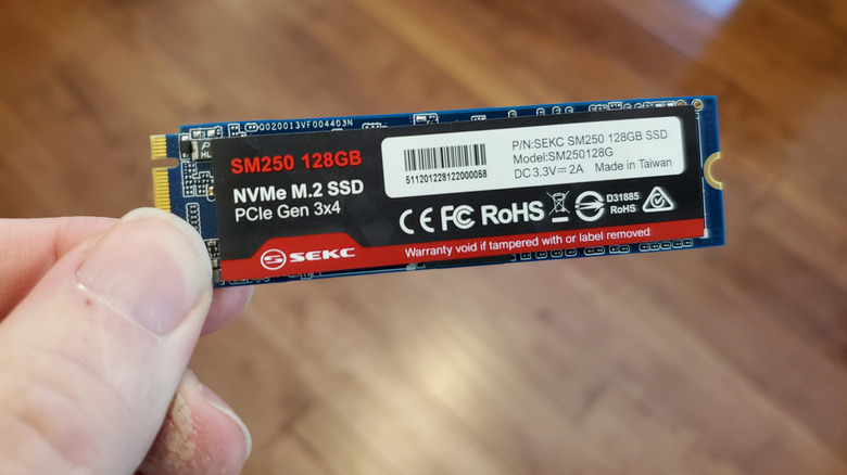 Fingers holding NVMe drive