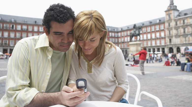 couple using flip phone