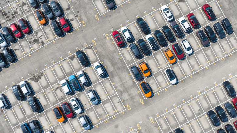Overhead view of a car parking lot, half-full.
