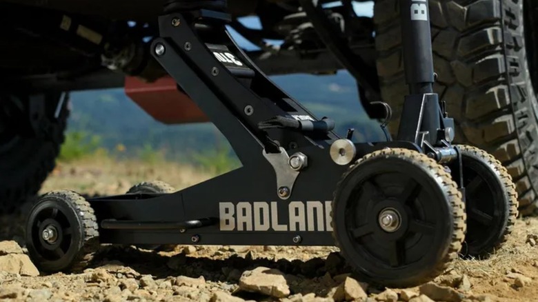 lifting a car on dirt road with Badland jack
