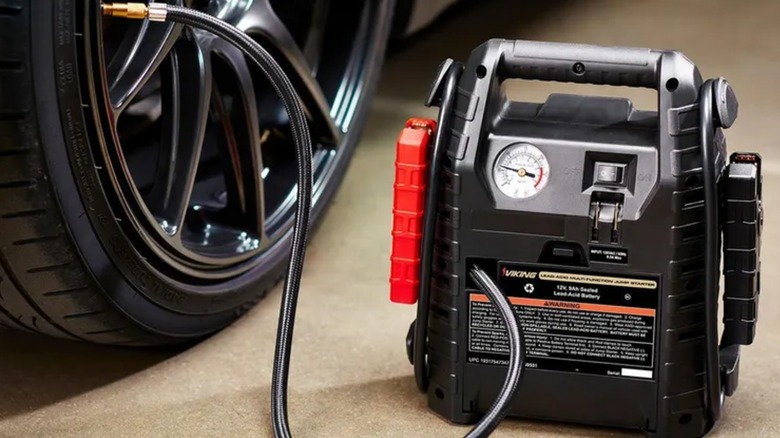 pumping a car tire with Viking jump starter tool
