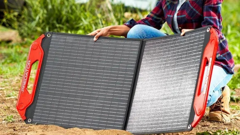 setting up Predator solar panel while outside near car