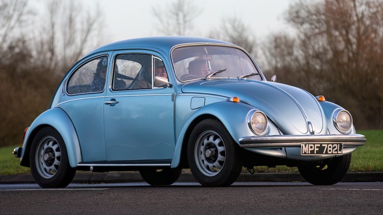 People driving in a classic VW Beetle