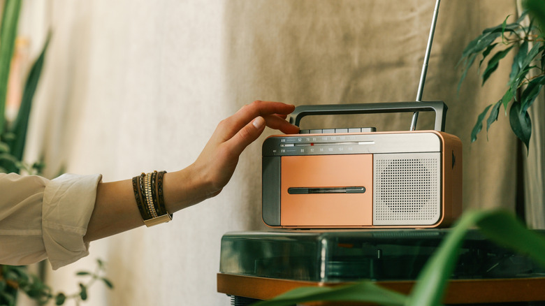 A person using an old-fashioned portable radio