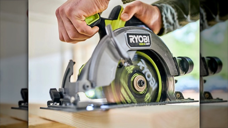 Cutting a wooden surface with a circular saw.