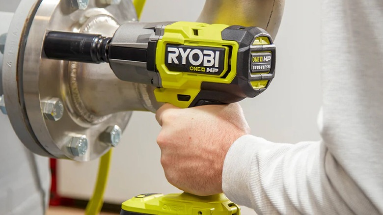 Mechanic removing bolts with Ryobi impact wrench