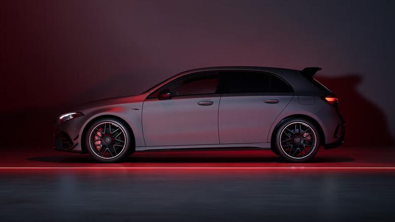 The side profile (left) of a 2025 AMG A45 S hatchback sports car, pictured here against a dark studio backdrop.