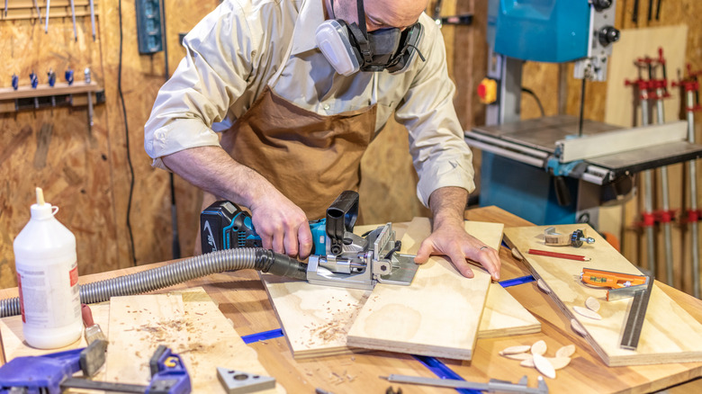 woodworker using a biscuit jointer