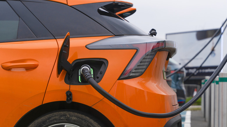 An electric car being charged at a charging station