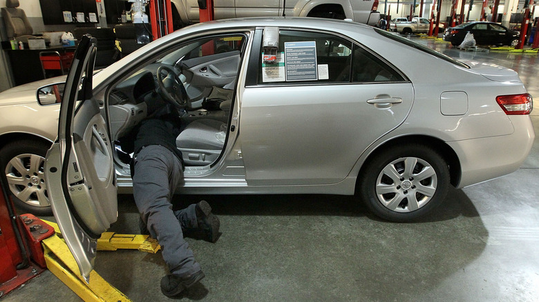 Mechanic works on Toyota Corolla