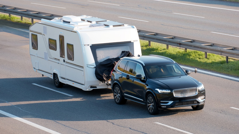 car towing trailer on the road