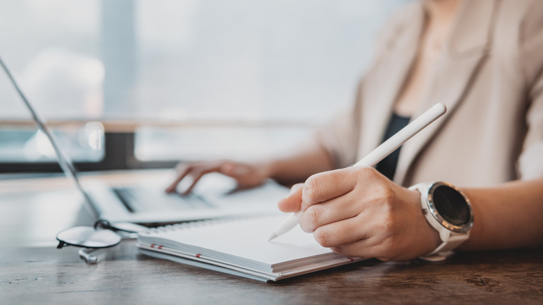 Woman writing a shortlist