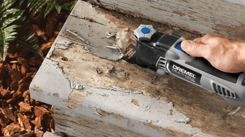 The Dremel Multi-Max MM35 Oscillating Tool Kit being used on a wooden surface