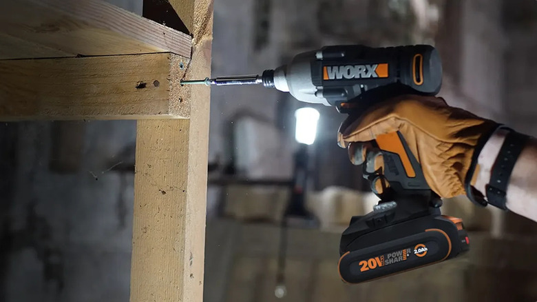 The Worx Power Share Cordless Impact Driver being used on a screw in wood