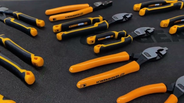 Closeup of a variety of GearWrench tools on a black surface