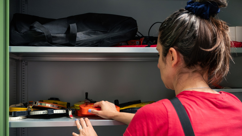 Woman organizing a set of tools in a storage space