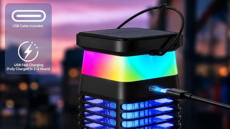 Light-up solar bug zapper lantern in dark showing alternate charging method of USB