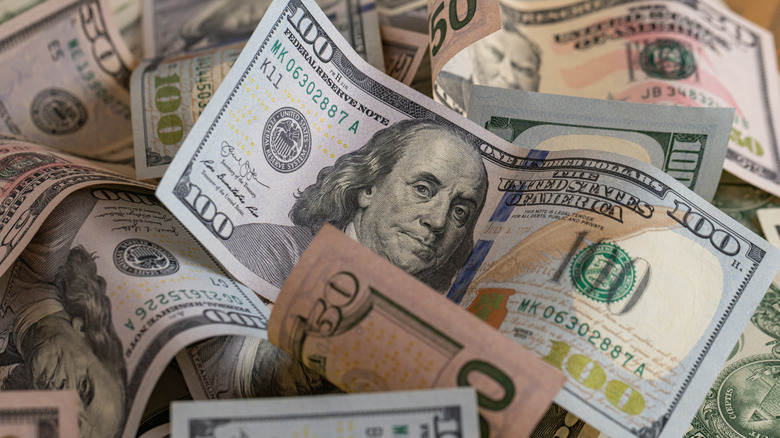 a pile of US 50 and 100-dollar bills