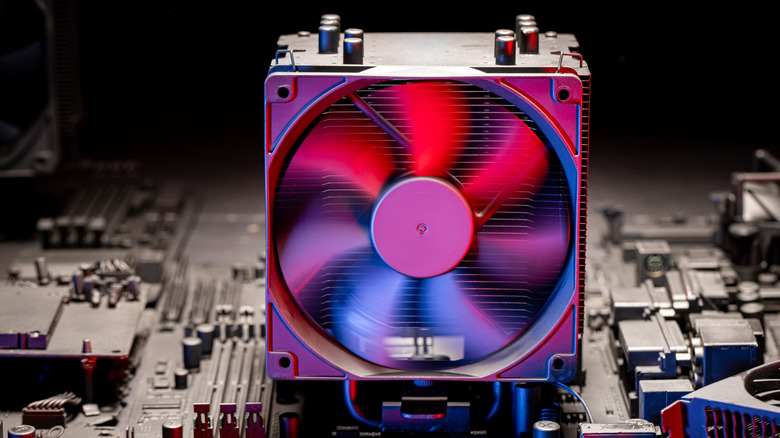 A computer CPU fan on top of a motherboard